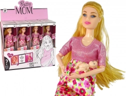 Ciężarna lalka w różowej sukience w kwiaty