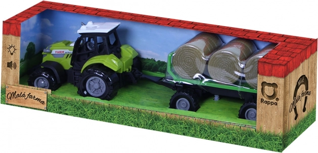 Traktor z dźwiękiem i światłem z przyczepą i belami słomy