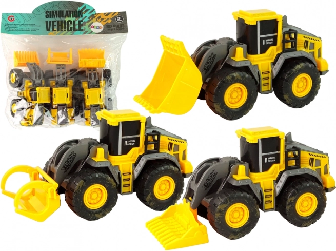 Zestaw trzech żółtych pojazdów budowlanych