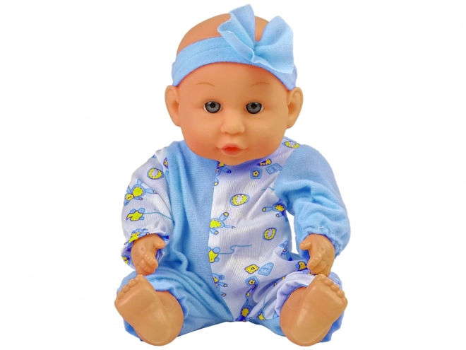 Laleczka niemowlę na nocnik z niebieską kokardką