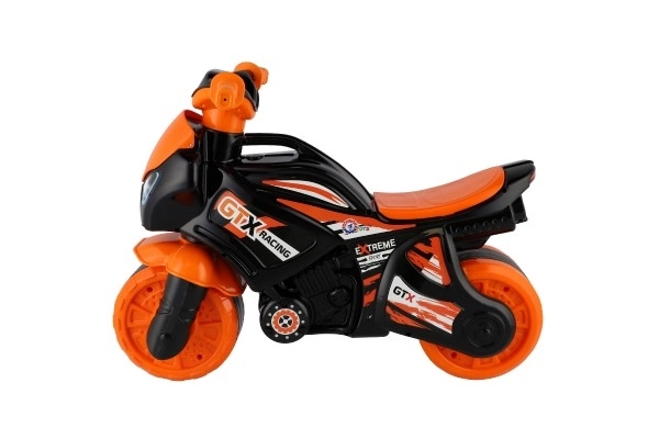 Jeździk motocykl pomarańczowo-czarny plastik w worku 35x53x74 cm 24m+