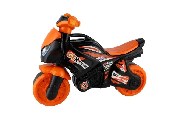 Jeździk motocykl pomarańczowo-czarny plastik w worku 35x53x74 cm 24m+