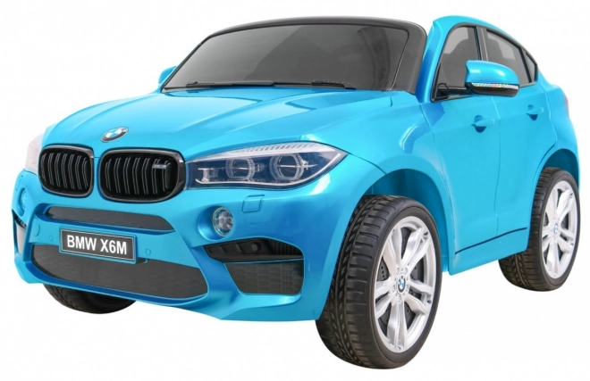 BMW X6M XXL pro 2 dzieci Niebieski kolor + Pilot + Eko skóra + Pasy bezpieczeństwa + Płynny start + MP3 + LED