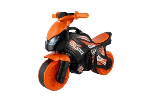 Jeździk motocykl pomarańczowo-czarny plastik w worku 35x53x74 cm 24m+