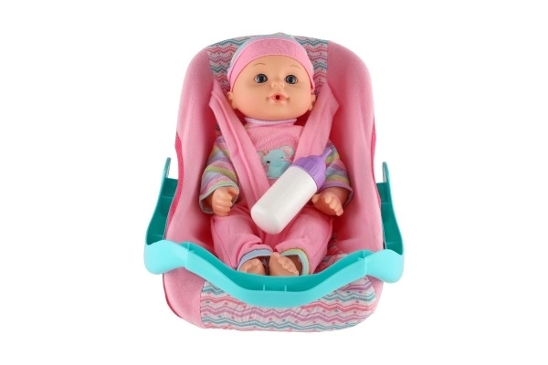 Lalka niemowlę 30cm z plastiku w nosidełku/fotelik samochodowy z butelką w blisterze