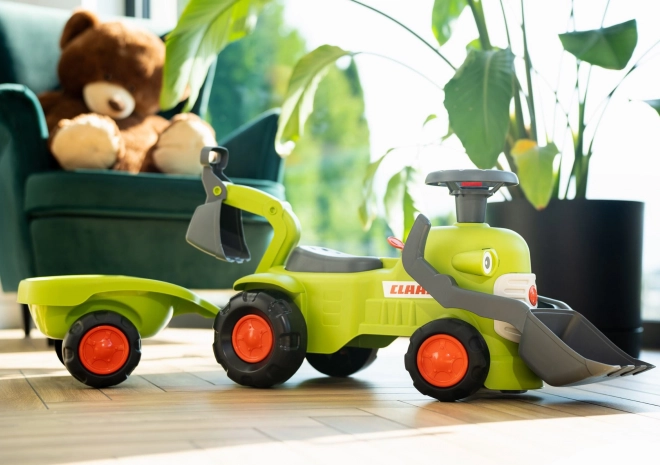 Jeżdżący traktor Claas z przyczepą, ładowaczem i łyżką