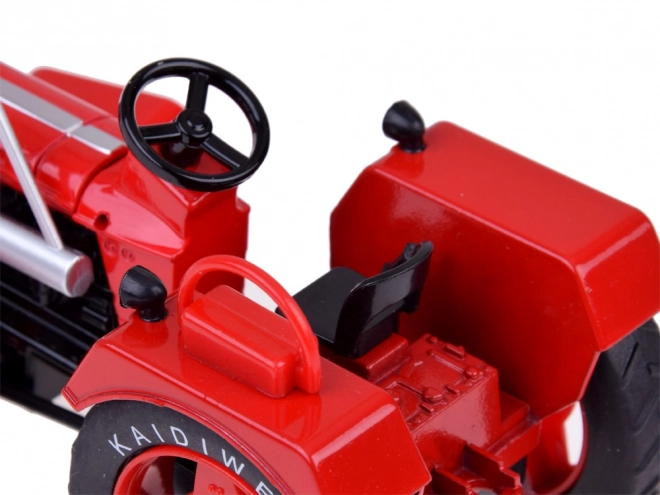 Czerwony metalowy traktor z gumowymi kółkami 1:18