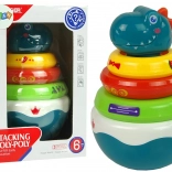 grzechotka dinozaur z kolorowymi kółeczkami i kołyszącą się podstawą